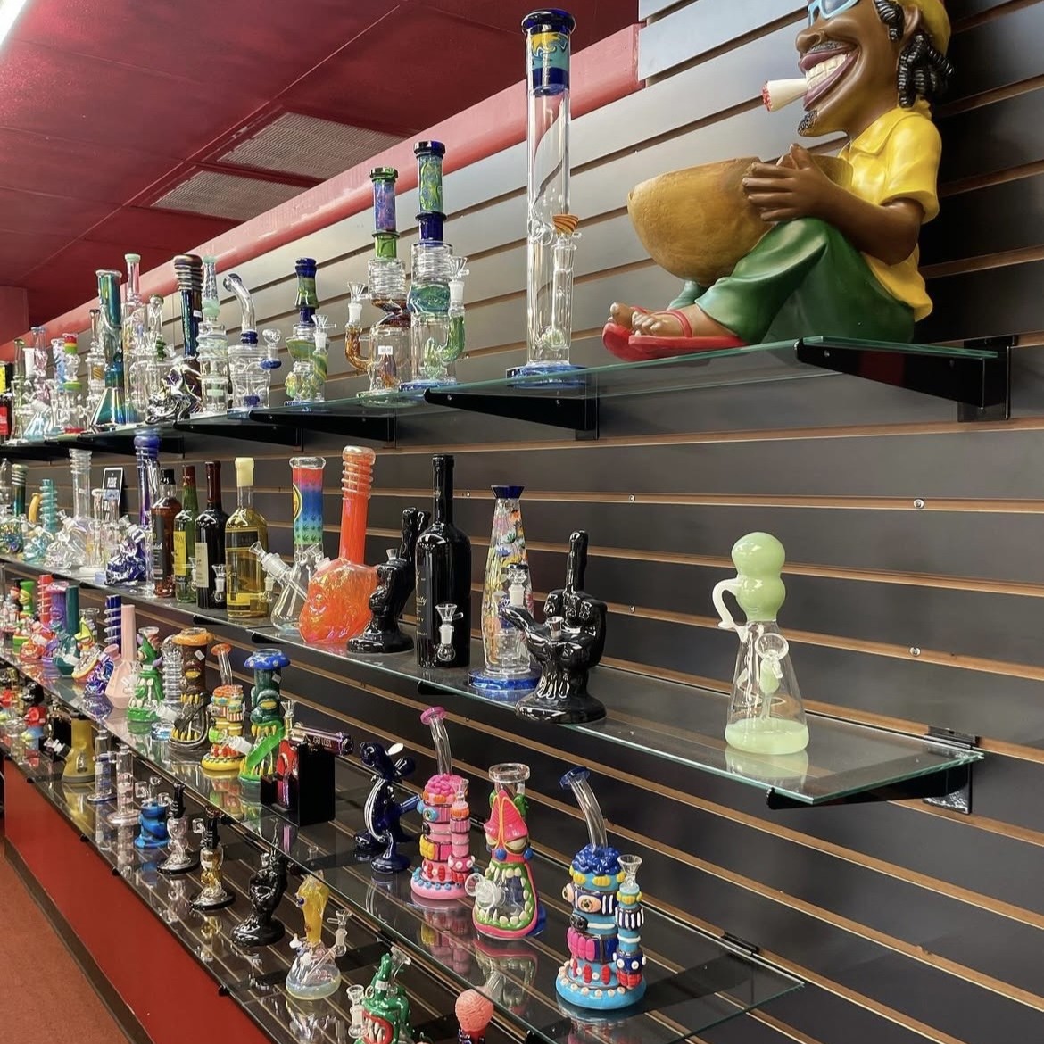 Large decorative glass bongs showcased on retail shelves