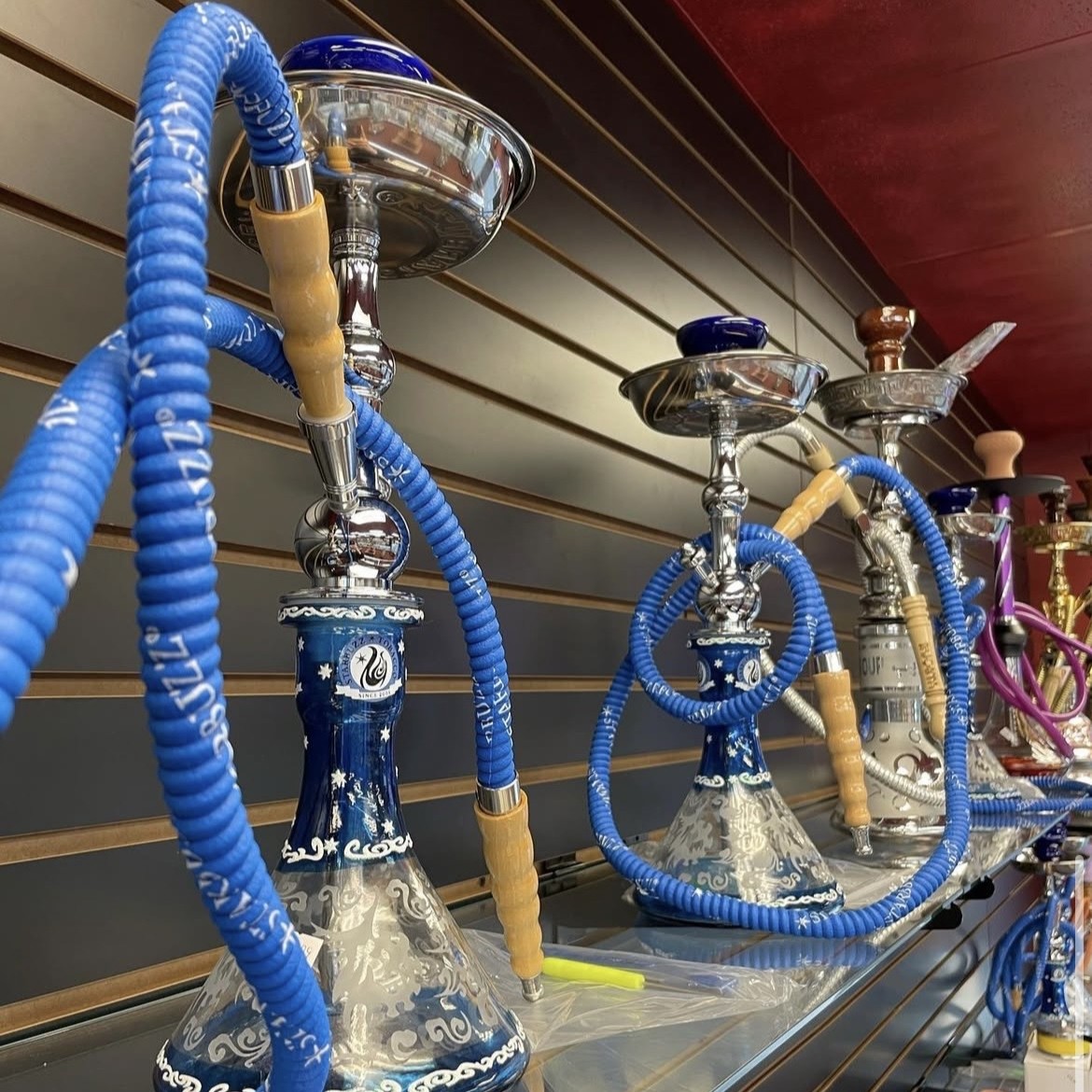 Large decorative glass bongs showcased on retail shelves